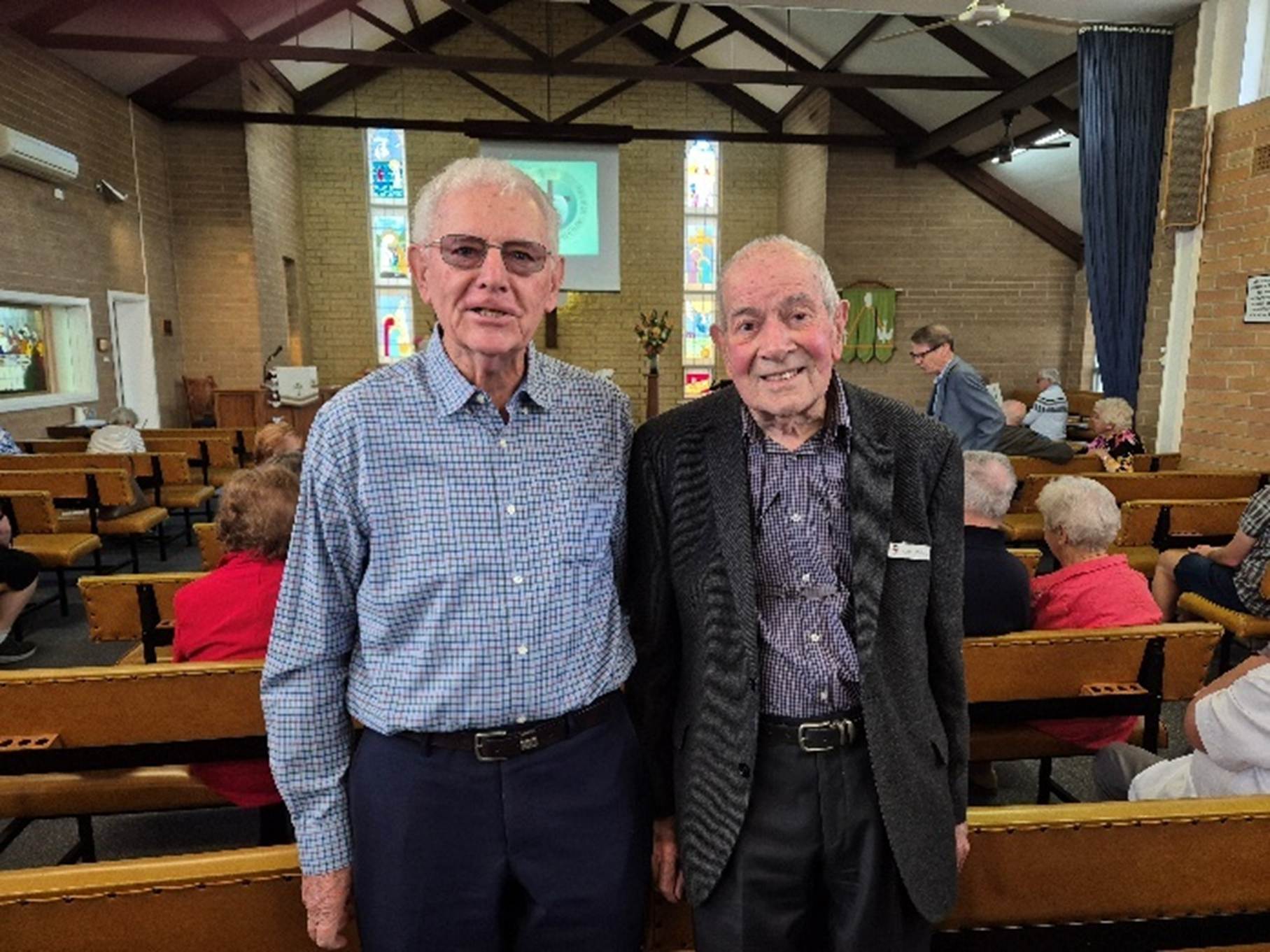 Two men standing in a church

AI-generated content may be incorrect.