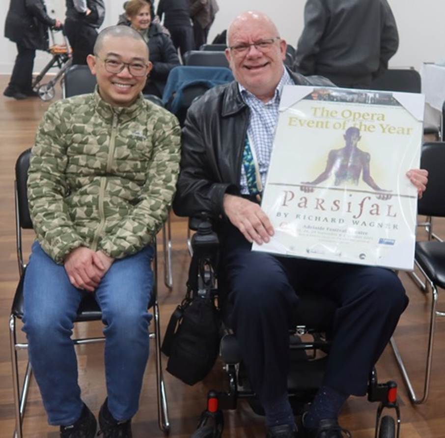 Two men sitting in wheelchairs holding a sign

AI-generated content may be incorrect.