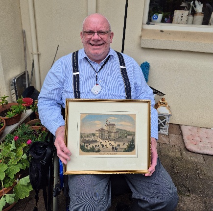 A person holding a framed picture

AI-generated content may be incorrect.